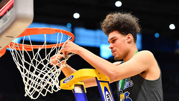 Lutheran East's Jesse McCulloch cuts down the nets after the winning the 2023 OHSAA Division III state championship